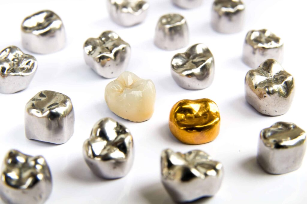 Various extracted gold and silver dental crowns for sell dental gold services.